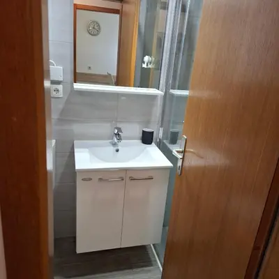 a bathroom with a white sink and a mirror at Bohinj Planika J2 in Bohinj