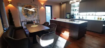 a kitchen with a table and chairs and a counter at Sončna oaza - Vila Melita in Moravske Toplice