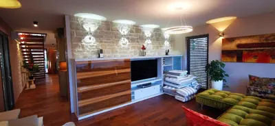 a living room with a couch and a tv in a room at Sončna oaza - Vila Melita in Moravske Toplice