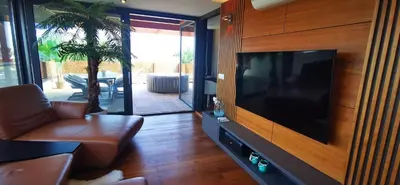 a living room with a large flat screen tv at Sončna oaza - Vila Melita in Moravske Toplice