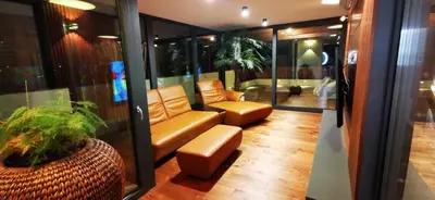 a room with a couch and a chair and a table at Sončna oaza - Vila Melita in Moravske Toplice