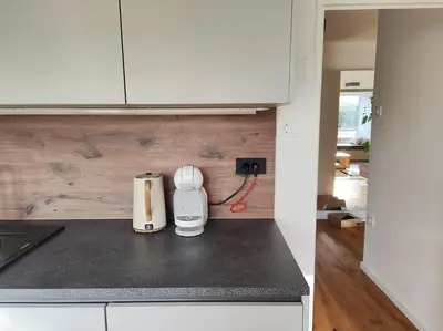 a kitchen counter with a toaster plugged into an outlet at Modern apartment Konjice in Slovenske Konjice