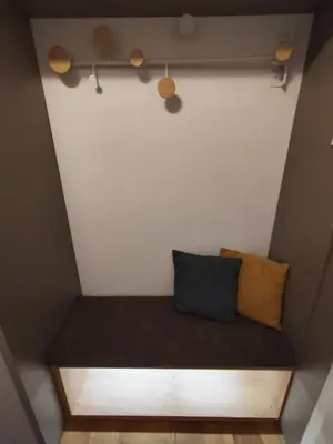 a bench with two pillows on it in a room at Modern apartment Konjice in Slovenske Konjice