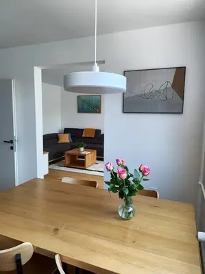 a dining room table with a vase of flowers on it at Modern apartment Konjice in Slovenske Konjice