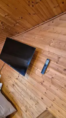 a remote control sitting on top of a wooden floor at Suita 305 in Kranjska Gora