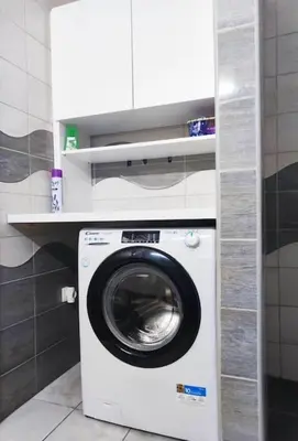 a washer and dryer in a small bathroom at Spacious Countryside Flat - 25 minutes from Ljubljana in Grosuplje