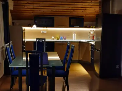 a kitchen with a table and chairs and a refrigerator at Spacious Countryside Flat - 25 minutes from Ljubljana in Grosuplje