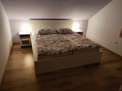 a bedroom with a bed and two night stands at Spacious Countryside Flat - 25 minutes from Ljubljana in Grosuplje