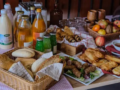 a table with baskets of different types of food and drinks at Pohorski Dom in Pohorje