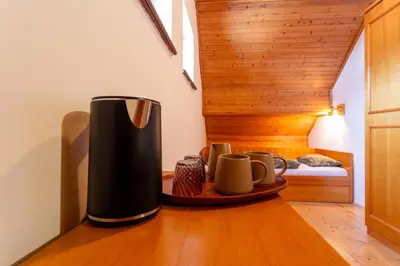 a coffee maker sitting on the floor in a room at Pohorski Dom in Pohorje