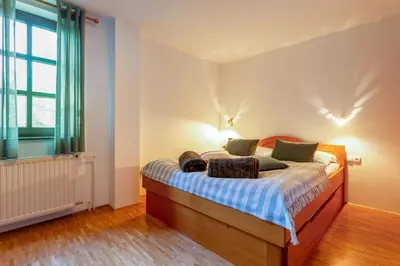 a bedroom with a bed and a window at Pohorski Dom in Pohorje