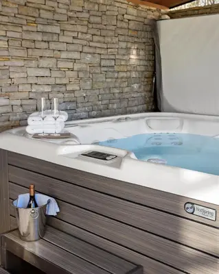 a bathroom with a bath tub with a sink at Wellness Chalet close to Ljubljana in Rakitna