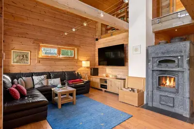 a living room with a couch and a fireplace at Wellness Chalet close to Ljubljana in Rakitna