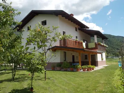 a house with a balcony on the side of it at Apartment and Room Natasa in Kobarid