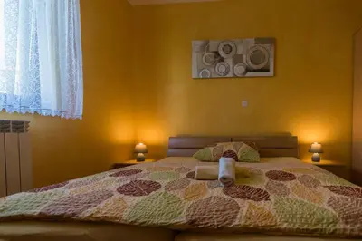 a bedroom with a bed with two speakers on the wall at Apartment and Room Natasa in Kobarid