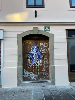 a wall with graffiti on the side of a building at Bridget's room in Ljubljana