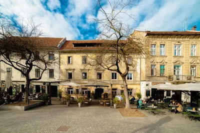 a building with tables and chairs in front of a building at Bridget's room in Ljubljana