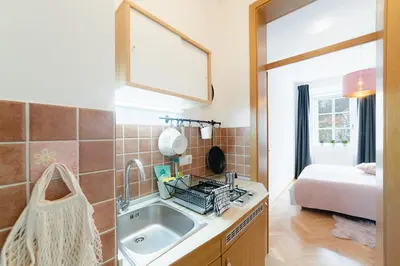 a kitchen with a sink and a bed in a room at Bridget's room in Ljubljana
