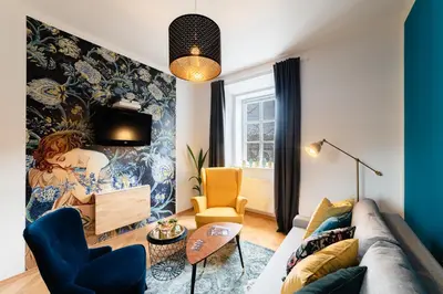 a living room with a couch and a wall mural at Bridget's room in Ljubljana