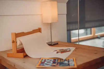 a white chair on a wooden table with a lamp at eco boutique hotel AMS Beagle in Bled