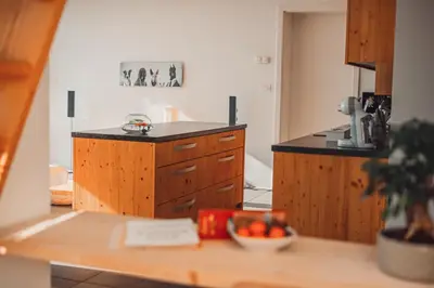 a kitchen with a bowl of fruit on a counter at eco boutique hotel AMS Beagle in Bled