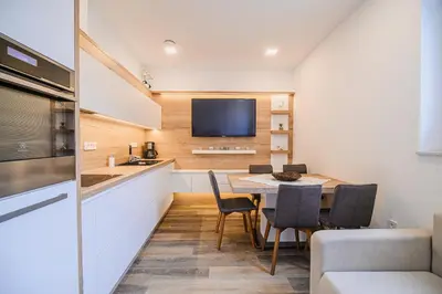 a kitchen and dining room with a table and chairs at Apartment Gorski Raj in Kranjska Gora