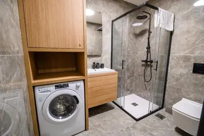 a bathroom with a washing machine and a shower at Apartment Gorski Raj in Kranjska Gora