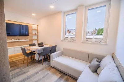 a living room with a couch and a table at Apartment Gorski Raj in Kranjska Gora