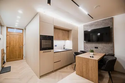 a kitchen and a dining room with a table and chairs at Apartment Gorski Raj in Kranjska Gora