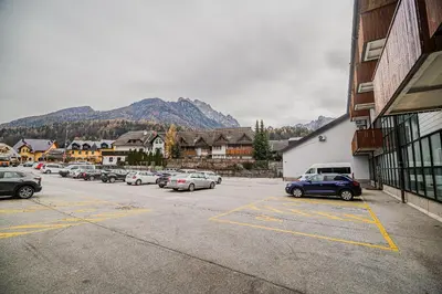 a parking lot with a bunch of cars parked at Apartment Gorski Raj in Kranjska Gora