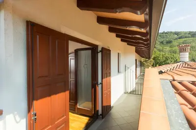an open door on a building with a balcony at Turistična kmetija Štanfel in Podsabotin