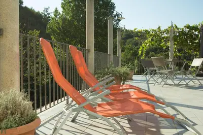 a pair of orange chairs sitting on a patio at Turistična kmetija Štanfel in Podsabotin