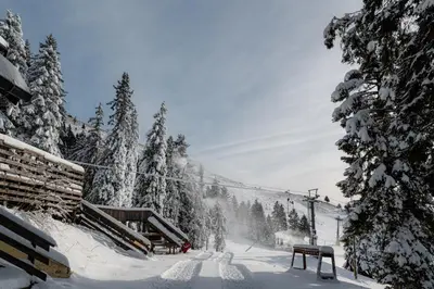 a snow covered ski slope with a ski lift at Old House - Krvavec ski resort in Cerklje na Gorenjskem