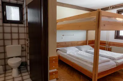 a bedroom with two bunk beds and a toilet at Old House - Krvavec ski resort in Cerklje na Gorenjskem