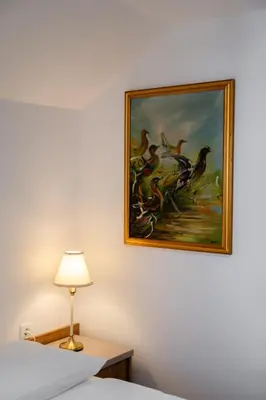 a painting of birds on the wall of a hotel room at Hiša S'TJE Krvavec ski resort in Cerklje na Gorenjskem