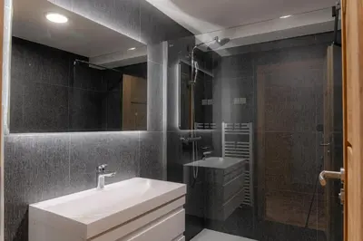 a bathroom with a sink and a shower at Hiša S'TJE Krvavec ski resort in Cerklje na Gorenjskem