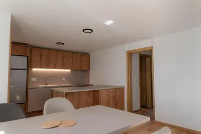 a kitchen with a table and a counter top at Hiša S'TJE Krvavec ski resort in Cerklje na Gorenjskem