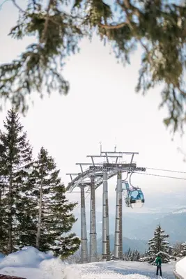 a person riding a ski lift in the snow at Hiša S'TJE Krvavec ski resort in Cerklje na Gorenjskem