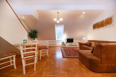 a living room with a table and a couch at Apartments at Villa Golf in Rogaška Slatina