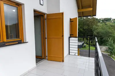 an open door of a house with a balcony at Zidanica sredi dolenjskih gričev - V gaj in Trebnje