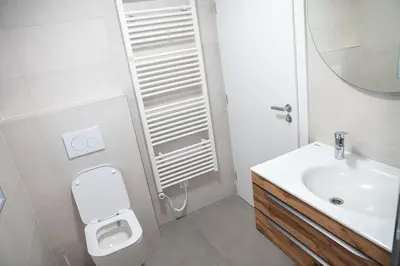 a white bathroom with a sink and a toilet at Zidanica sredi dolenjskih gričev - V gaj in Trebnje