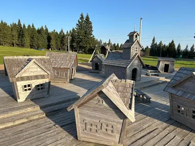 a group of wooden play houses on a deck at Apartma Planinski Raj in Zreče