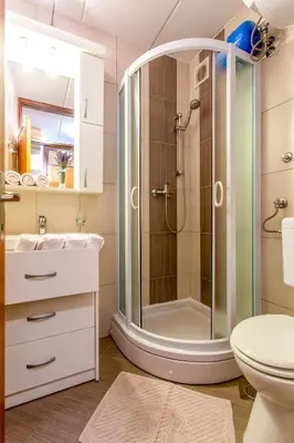 a bathroom with a shower and a toilet at Apartma Planinski Raj in Zreče