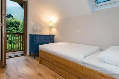 a bedroom with a bed and a window at Chalet Ceri in Bohinj