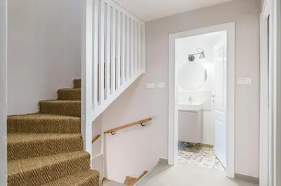 a white hallway with stairs and a sink at Chalet Ceri in Bohinj