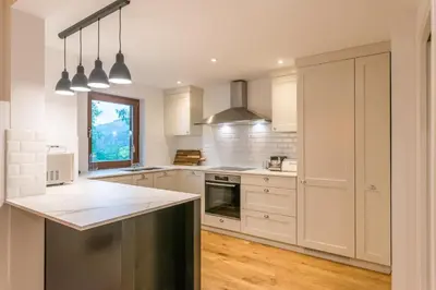 a kitchen with white cabinets and a counter top at Chalet Ceri in Bohinj