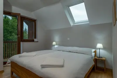 a bedroom with a bed with two towels on it at Chalet Ceri in Bohinj