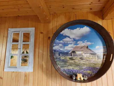 a mirror on the side of a wall with a window at Koča Lipa pod Veliko planino in Luče