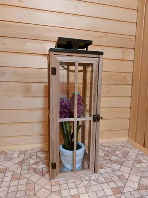 a wooden box with a vase of flowers in it at Koča Lipa pod Veliko planino in Luče
