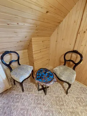 two chairs sitting in the corner of a room at Koča Lipa pod Veliko planino in Luče